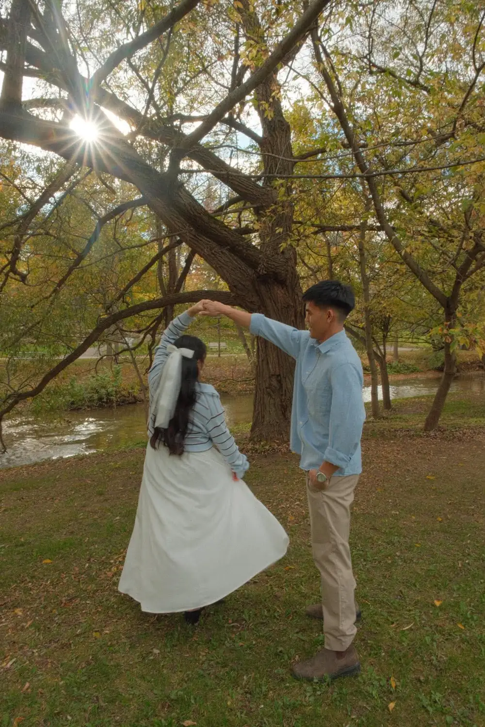 Earl twirls Den beneath a willow by the river